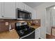 Close-up of a kitchen featuring stainless steel appliances and modern cabinetry at 105 Stoney Dr, Durham, NC 27703