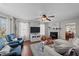 Cozy living room featuring a fireplace, comfortable seating, and a ceiling fan at 105 Stoney Dr, Durham, NC 27703