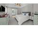 Bright main bedroom featuring a tray ceiling, ceiling fan, and ensuite bathroom at 105 Stoney Dr, Durham, NC 27703