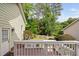Wood deck overlooking a landscaped yard with a white fence and mature trees at 10516 Cokesbury Ln, Raleigh, NC 27614