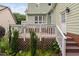 View of a backyard deck with greenery, steps, lattice, and upper level awning at 10516 Cokesbury Ln, Raleigh, NC 27614