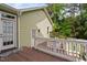 Wooden deck with a white railing, offering a view of the landscaped backyard at 10516 Cokesbury Ln, Raleigh, NC 27614