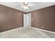 Spacious bedroom featuring neutral carpet, ceiling fan and a doorway leading to another room at 10516 Cokesbury Ln, Raleigh, NC 27614