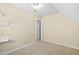 Upstairs bedroom featuring angled walls, carpeted floors, and bright light at 10516 Cokesbury Ln, Raleigh, NC 27614