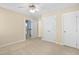Bedroom with a ceiling fan, carpeted floor, and white doors with brass hardware at 10516 Cokesbury Ln, Raleigh, NC 27614