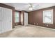 Brown bedroom with carpet, two windows with blinds, and white trim throughout at 10516 Cokesbury Ln, Raleigh, NC 27614