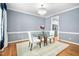 Elegant dining room with a glass table, chandelier, and hardwood floors at 10516 Cokesbury Ln, Raleigh, NC 27614