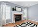 Beautiful fireplace with a white mantel and brick surround, adding charm to the room at 10516 Cokesbury Ln, Raleigh, NC 27614