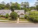 An elevated front yard view of home with mature trees and a tidy landscape at 10516 Cokesbury Ln, Raleigh, NC 27614