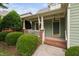Inviting front porch with a classic swing, perfect for enjoying the outdoors at 10516 Cokesbury Ln, Raleigh, NC 27614