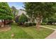 Well-maintained front yard with lush greenery and mature trees surrounding the house at 10516 Cokesbury Ln, Raleigh, NC 27614