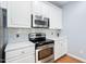 Bright kitchen featuring stainless steel appliances and white cabinets at 10516 Cokesbury Ln, Raleigh, NC 27614