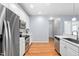 Bright kitchen with stainless steel appliances, white cabinets and stylish backsplash at 10516 Cokesbury Ln, Raleigh, NC 27614