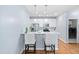 Bright kitchen featuring stainless steel appliances, a breakfast bar, and access to a laundry room at 10516 Cokesbury Ln, Raleigh, NC 27614