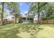 Spacious backyard featuring a well-maintained lawn, mature trees, and a classic wood fence for added privacy at 106 E Delafield Ave, Durham, NC 27704