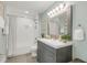 This well-lit bathroom features a shower-tub combo and a gray vanity with bright lighting at 106 E Delafield Ave, Durham, NC 27704