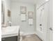 Bathroom featuring a vanity, framed art, and a shower with white tile at 106 E Delafield Ave, Durham, NC 27704