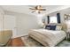 This primary bedroom features natural lighting, wood floors, and a ceiling fan at 106 E Delafield Ave, Durham, NC 27704