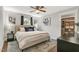 This primary bedroom offers a fan, nice window views, and an organized walk-in closet at 106 E Delafield Ave, Durham, NC 27704