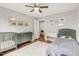 Shared ' bedroom featuring a single bed, dresser and crib, with wood floors at 106 E Delafield Ave, Durham, NC 27704