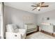 Bright Bedroom featuring a modern crib, changing table, and comfortable rocking chair at 106 E Delafield Ave, Durham, NC 27704