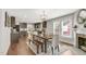Open-concept dining room featuring wood table, with natural light adjacent to kitchen at 106 E Delafield Ave, Durham, NC 27704