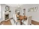 Elegant dining room with hardwood floors, fireplace and a wooden dining table set for four at 106 E Delafield Ave, Durham, NC 27704