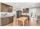 Modern kitchen features updated stainless appliances, custom cabinets and hardwood floors at 106 E Delafield Ave, Durham, NC 27704