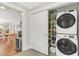 Efficient laundry room featuring a stackable washer and dryer, with an adjacent pantry at 106 E Delafield Ave, Durham, NC 27704