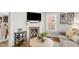Cozy living room featuring a brick fireplace with decorative items and natural light at 106 E Delafield Ave, Durham, NC 27704