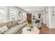 Open-concept living room with a comfortable couch, hardwood floors, and stylish decor at 106 E Delafield Ave, Durham, NC 27704
