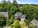 Home with well-manicured lawn and landscaping in a neighborhood surrounded by mature trees at 107 Ashwick Ct, Cary, NC 27513