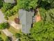 Aerial view of house with a well-manicured lawn, mature trees, and a spacious driveway at 107 Ashwick Ct, Cary, NC 27513