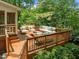 Spacious wood deck with outdoor seating, grill, and access to the screened porch at 107 Ashwick Ct, Cary, NC 27513