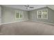Bright, spacious bedroom with neutral walls, carpet and two large windows allowing natural light at 107 Ashwick Ct, Cary, NC 27513