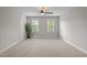 Bedroom with neutral carpet, two bright windows, and a ceiling fan at 107 Ashwick Ct, Cary, NC 27513