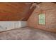 Carpeted bedroom features a wood-paneled ceiling and accent wall made of stone at 107 Ashwick Ct, Cary, NC 27513