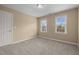 Bedroom featuring neutral carpet and two bright windows at 107 Ashwick Ct, Cary, NC 27513
