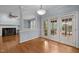 Charming dining area with fireplace access, ample lighting, and access to outdoor space, perfect for entertaining at 107 Ashwick Ct, Cary, NC 27513