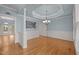 Spacious dining room showcases hardwood floors, tray ceiling, and neutral wall color at 107 Ashwick Ct, Cary, NC 27513