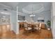 Elegant dining room features tray ceiling, wood floors, and classic chandelier at 107 Ashwick Ct, Cary, NC 27513