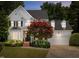 Charming two-story home with lush landscaping, brick stairs, and a two-car garage at 107 Ashwick Ct, Cary, NC 27513