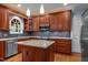 Beautiful kitchen featuring granite countertops, stainless steel appliances, custom cabinetry, and modern lighting at 107 Ashwick Ct, Cary, NC 27513