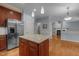 Open-concept kitchen with granite counters, stainless appliances, a center island, and seamless flow into living areas at 107 Ashwick Ct, Cary, NC 27513