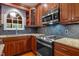 Well-equipped kitchen featuring stainless steel appliances, granite countertops, ample cabinet space, and modern finishes at 107 Ashwick Ct, Cary, NC 27513