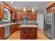 Gourmet kitchen featuring granite countertops, stainless steel appliances, custom cabinetry, and a center island at 107 Ashwick Ct, Cary, NC 27513
