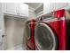 Modern laundry room features a side-by-side washer and dryer set and white storage cabinets at 107 Ashwick Ct, Cary, NC 27513