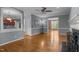 Open-concept living area featuring hardwood floors, neutral paint, and seamlessly connected spaces for modern living at 107 Ashwick Ct, Cary, NC 27513