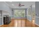 Bright living room showcasing a fireplace, hardwood floors, and large windows offering scenic views at 107 Ashwick Ct, Cary, NC 27513