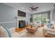 Inviting living room with fireplace, ceiling fan, and ample natural light, creating a cozy and stylish atmosphere at 107 Ashwick Ct, Cary, NC 27513